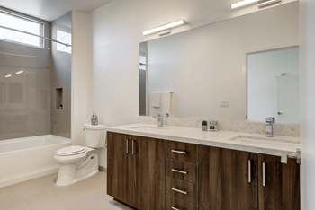 a bathroom with a sink toilet and a mirror